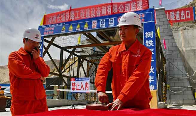 Workers celebrate holing-through of Galashan Tunnel in Lhasa, SW China's Tibet