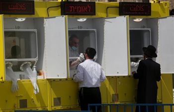 People receive COVID-19 tests at coronavirus testing booth in Jerusalem