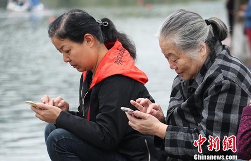 图为中国中老年女性使用智能手机上网。(资料图) 刘占昆 摄